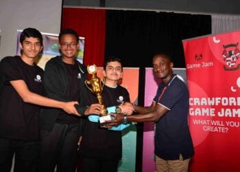 Crawford International School student Game Jam champions (from left) Izhar Mehdi, Khalid Abdi and Haider Rashid  from Nairobi Jaffery Academy receive their awards from Arthur Maria (right) , the Crawford International School Acting Principal, Middle School