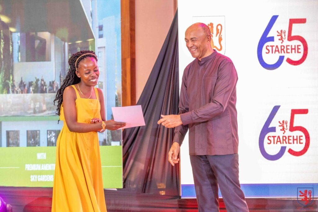 Old Starehian Society, Patron, Peter Kenneth hands a certificate to one of the Alumni during the 65th anniversary celebrations of Starehe Boy’s Centre.
