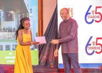 Old Starehian Society, Patron, Peter Kenneth hands a certificate to one of the Alumni during the 65th anniversary celebrations of Starehe Boy’s Centre.