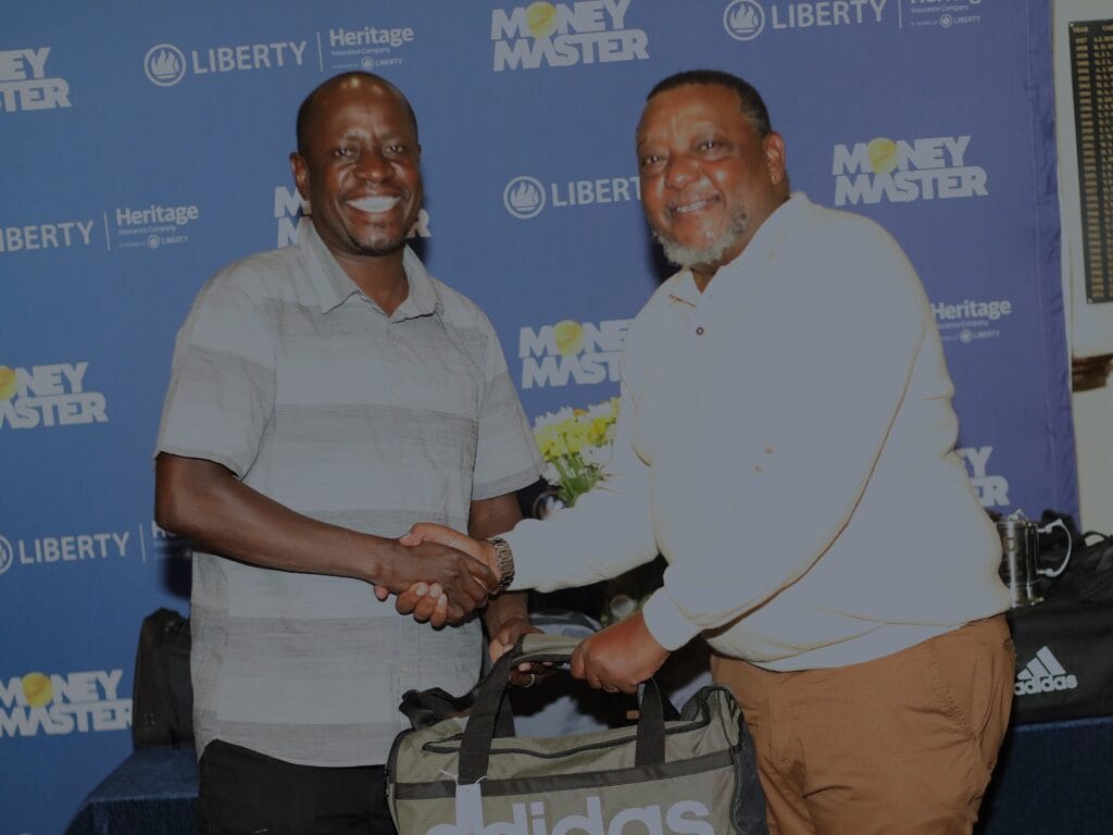 Liberty Kenya GM, People and Culture Felix Ochieng (left) awards the staff winner prize to Liberty Life MD, Nkoregamba Mwebesa during the January Mug golf prize giving event.