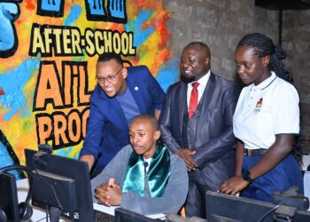 (l-r) Robin Njuno, Managing Executive, Learning & Development, CCI Global; John Kiria, Director ICT, E-commerce and entrepreneurship division, State Department for ICT and digital economy; and Linda Nyaseda, Head of City Management and DCC, Tatu City look on as Nathaniel Kang'ethe, a student at Tatu Primary School