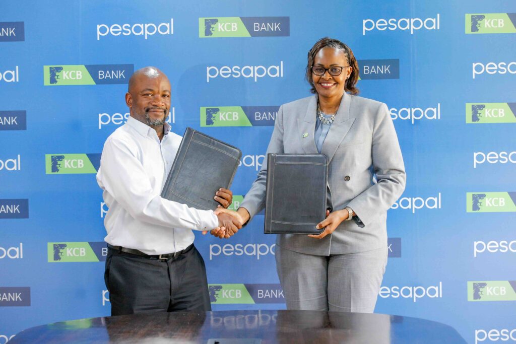KCB Bank Kenya Managing Director, Annastacia Kimtai, and Pesapal Founder, Agosta Liko, during the signing of a strategic partnership between KCB Bank Kenya and Pesapal Limited.