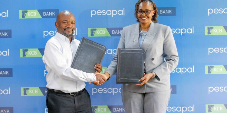 KCB Bank Kenya Managing Director, Annastacia Kimtai, and Pesapal Founder, Agosta Liko, during the signing of a strategic partnership between KCB Bank Kenya and Pesapal Limited.