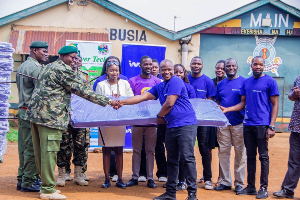 Hudson Gariamba, Branch Manager, Busia, I&M Bank handing over mattresses blankets & footwear to the prison to improve inmate hygiene and welfare