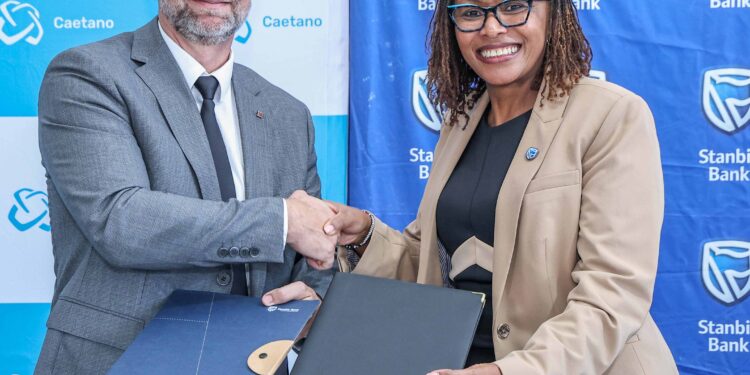 Stanbic Bank Regional Head, East Africa, Business and Commercial Banking, Florence Wanja and Salvador Caetano, Kenya Limited Managing Director, Aurelien Glay, during the signing of the Memorandum of Understanding between the two companies.