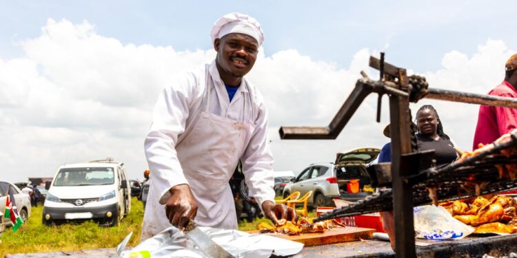 Job Osero, a business vendor from Nairobi, serves customers Nyama Choma at the Sleeping Warrior Spectator Stage during the 2026 WRC Safari Rally in Naivasha.