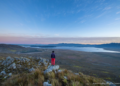 A crew member with The Greater Cape Town Water Fund looks out over the landscape where the team is working to remove invasive alien plants for improved water security.