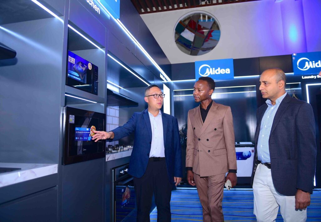 L-R: Bright Yao, General Manager, Midea Africa, engages Jeremy Kireru, Sales Director at White Horse Real Estate, and Rakesh Singh, Managing Director of Opalnet Limited, during the Midea Dealers Conference in Nairobi,