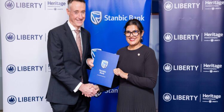 Kieran Godden, Group CEO, Liberty Kenya Holdings Plc, and Anjali Harkoo, Head of Insurance and Asset Management at Stanbic Bank Kenya, during the signing of a Vehicle and Asset Financing partnership between Stanbic Bank and Liberty Kenya.