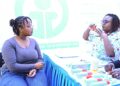 Lynnet Mwikya, an asthma patient, being taught how to use an inhaler by Veronicah Waruingi, a nurse at Gertrude's Children's Hospital