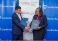 Stanbic bank Kenya’s Regional Executive Head Business & Commercial banking, Florence Wanja signs and exchanging signed documents with Simba Corporation Group CEO, Dinesh Kotecha, during the signing of a Memorandum of Understanding (MOU) at their head office in Nairobi. Simba Corp owns and operates Associated Vehicle Assemblers Limited, one of East Africa’s largest vehicle assembly plants. AVA assembles trucks, pickups, buses, and passenger vehicles for several global brands.