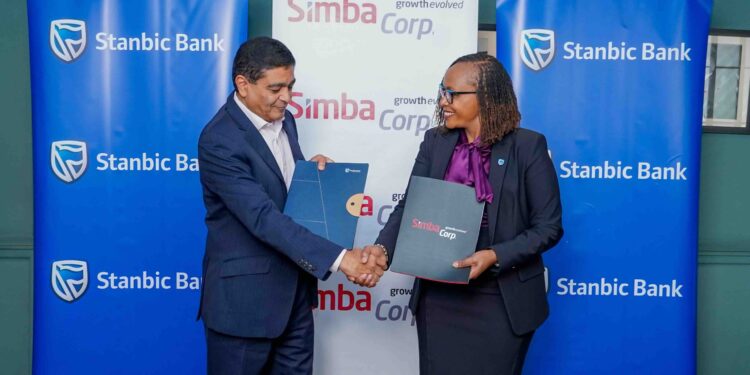 Stanbic bank Kenya’s Regional Executive Head Business & Commercial banking, Florence Wanja signs and exchanging signed documents with Simba Corporation Group CEO, Dinesh Kotecha, during the signing of a Memorandum of Understanding (MOU) at their head office in Nairobi. Simba Corp owns and operates Associated Vehicle Assemblers Limited, one of East Africa’s largest vehicle assembly plants. AVA assembles trucks, pickups, buses, and passenger vehicles for several global brands.