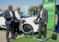 Matatu Owners Association President Albert Karagacha, KCB Unit Head, Asset Finance and Insurance, Juliana Kinyua, and ePureMotion CEO Gilbert Saggia demonstrate the EV charging system during the official launch of an EV charging site for Matatu Owners Association vehicles in Buruburu, Nairobi, on July 14, 2026.