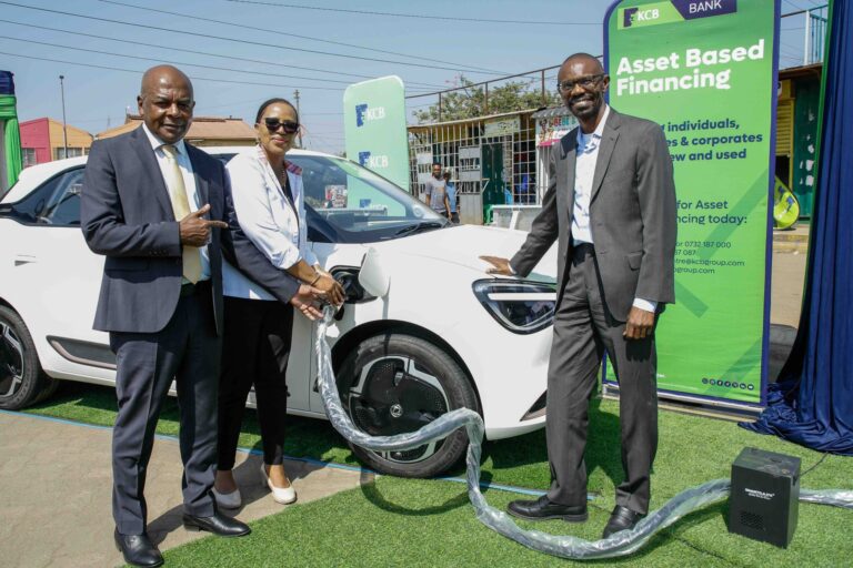 Matatu Owners Association President Albert Karagacha, KCB Unit Head, Asset Finance and Insurance, Juliana Kinyua, and ePureMotion CEO Gilbert Saggia demonstrate the EV charging system during the official launch of an EV charging site for Matatu Owners Association vehicles in Buruburu, Nairobi, on July 14, 2026.