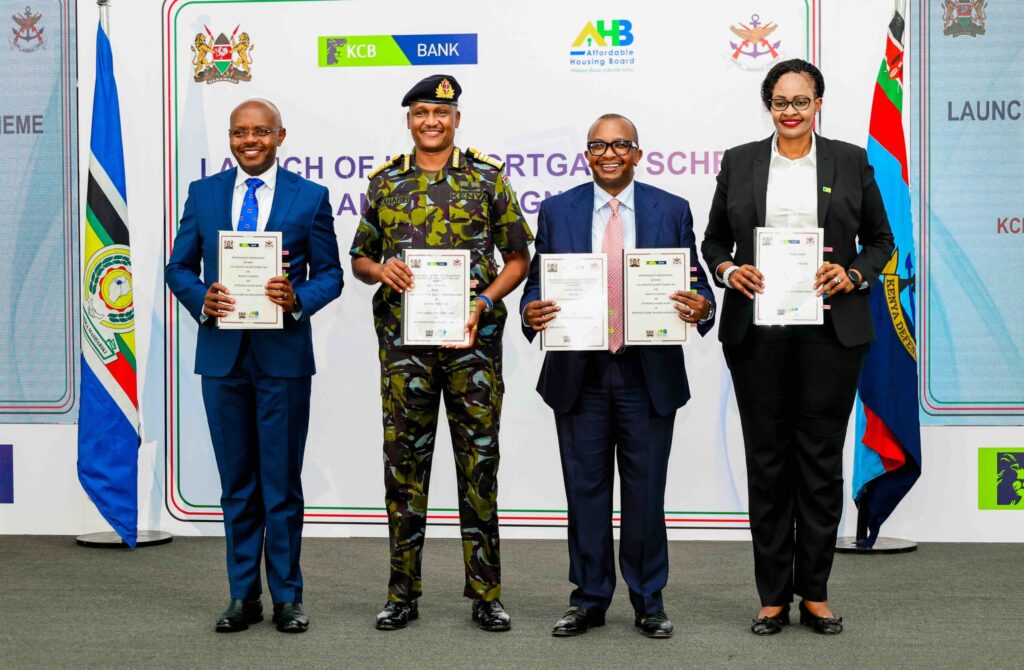Defence PS Dr Patrick Mariru, Chief of the Defence Forces General Charles Kahariri, Housing PS Charles Hinga, and KCB Bank Kenya MD Annastacia Kimtai display the signed MOU allowing KDF officers to buy units under the Affordable Housing Programme under the Civil servants' mortgage scheme at 4% interest.