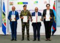 Defence PS Dr Patrick Mariru, Chief of the Defence Forces General Charles Kahariri, Housing PS Charles Hinga, and KCB Bank Kenya MD Annastacia Kimtai display the signed MOU allowing KDF officers to buy units under the Affordable Housing Programme under the Civil servants' mortgage scheme at 4% interest.