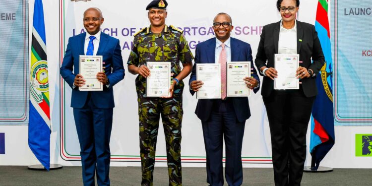 Defence PS Dr Patrick Mariru, Chief of the Defence Forces General Charles Kahariri, Housing PS Charles Hinga, and KCB Bank Kenya MD Annastacia Kimtai display the signed MOU allowing KDF officers to buy units under the Affordable Housing Programme under the Civil servants' mortgage scheme at 4% interest.