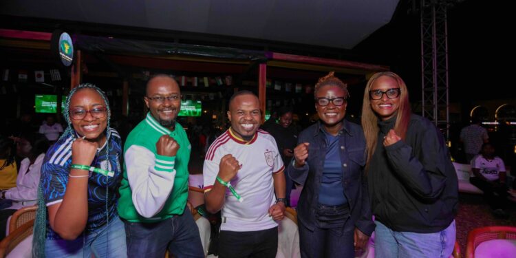 Sheila Changangu, Marketing Director, Visa East Africa, and Andrew Kabeke, CEO, Safaricom Money Transfer Services Limited, reward M-Pesa GlobalPay Virtual Visa card customers Ashley Kibara and Mayaka Hassan at the Semi-Final Watch Party.