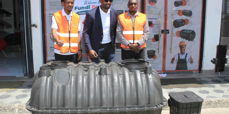 Edwin Kirugo (centre) with two plumbers at the Biotank Africa Fundi Forum event held in Kitengela town